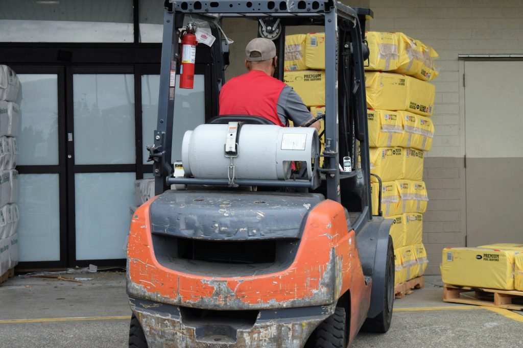 Forklift loading palletised goods at a commercial depot