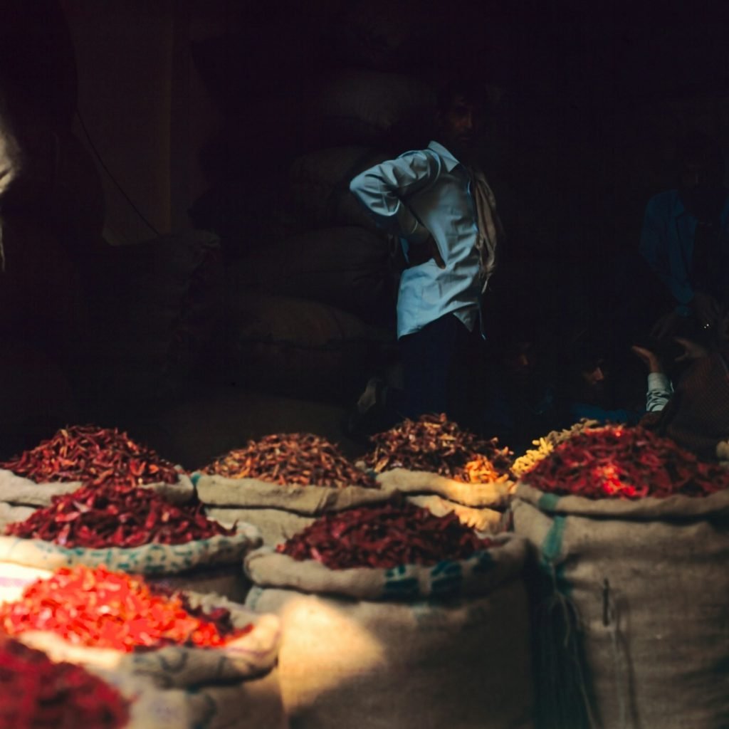 Jute sacks filled with dried red chillies and whole spices at a wholesale market